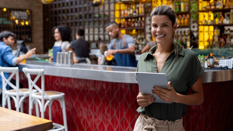 Host smiling waiting to seat customers