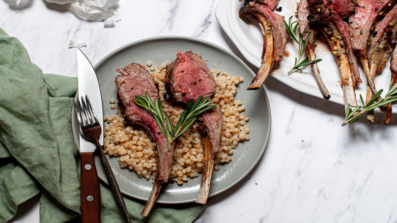 Lamb slices and quinoa on plate
