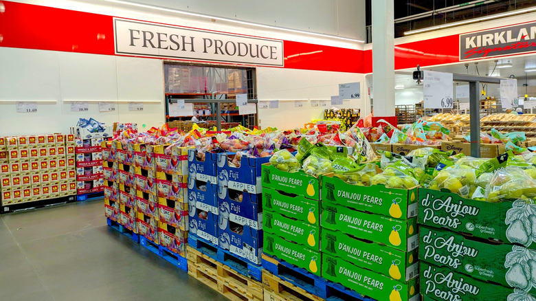 Fresh Produce signage at Costco with assorted fruit in the foreground.