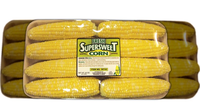Eight-pack of shucked corn wrapped in plastic with label on front.