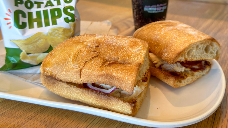 Panera Bread sandwich with chips and a drink