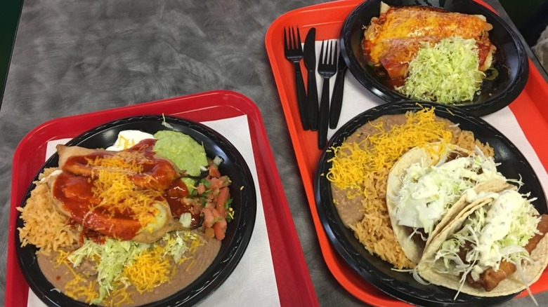 Three big plates of Mexican food on a table at Filiberto's Mexican Food