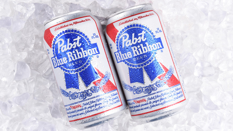 2 cans of pabst blue ribbon beer on ice