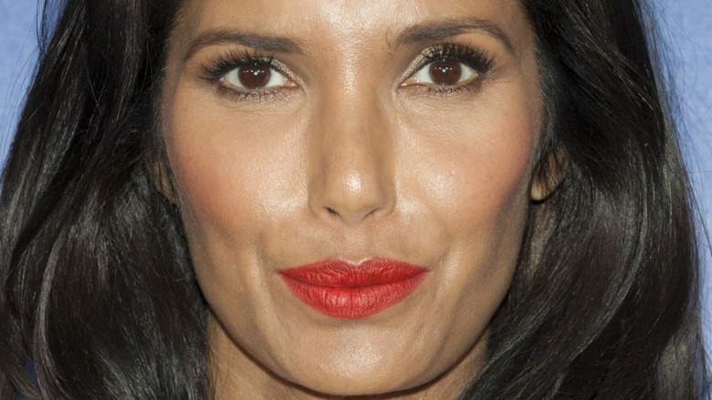 Padma Lakshmi with red lipstick and slight smile