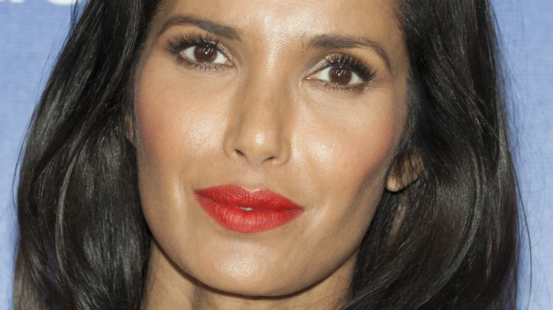 Padma Lakshmi with red lipstick and slight smile