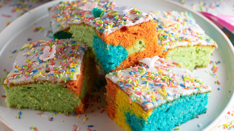 Rainbow sheet cake with sprinkles and pink icing