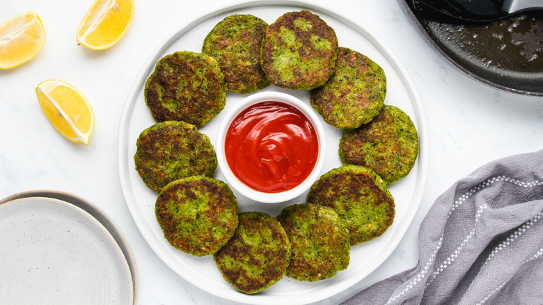 plate of broccoli fritters with ketchup
