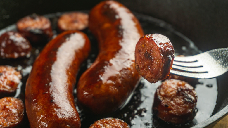 Close up of sausage links browned to perfection in pan