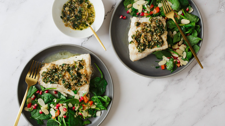 two plates of grouper with sauce in bowl