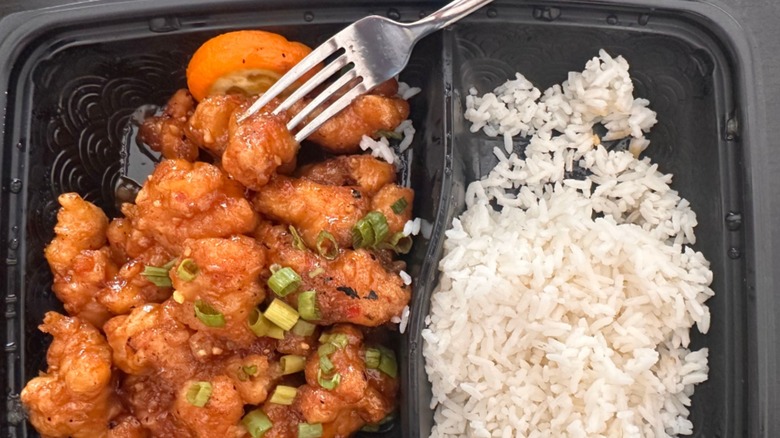 Orange chicken and rice with a fork