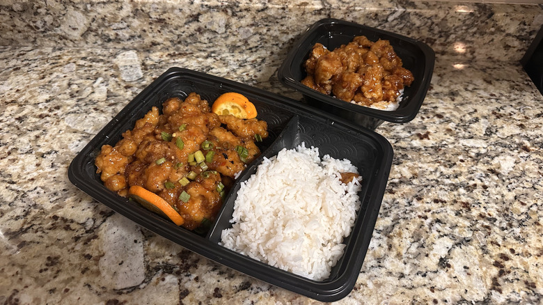 Takeout containers of orange chicken