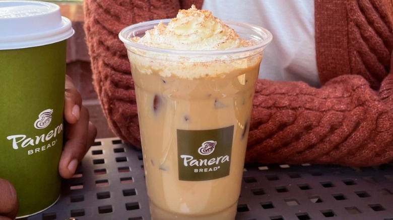 Panera latte with whipped cream and bagel