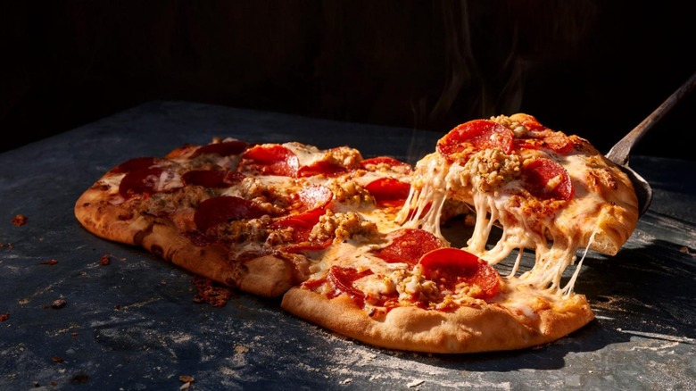 Sausage & Pepperoni Flatbread Pizza being served