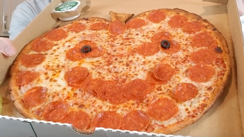 Jack-o-Lantern pizza displayed for review