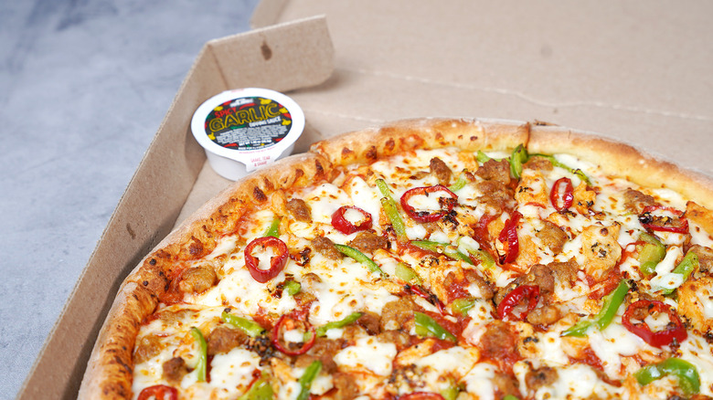 closeup of Papa John's Dragon Flame pizza with garlic sauce