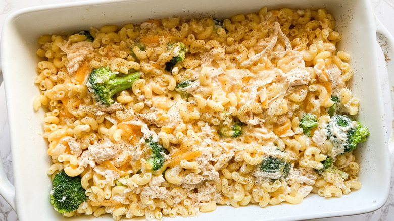 white baking dish full of chicken broccoli mac and cheese