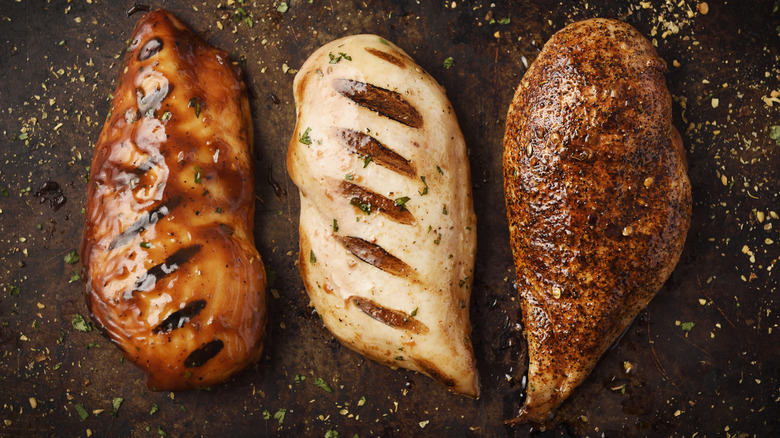 three cooked and seasoned chicken breasts