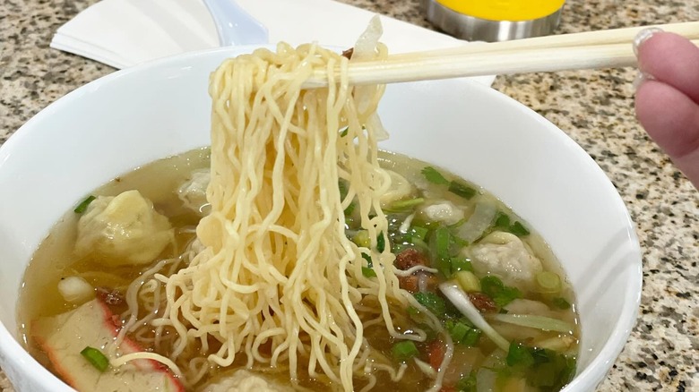 bowl of pho with chopsticks and noodles