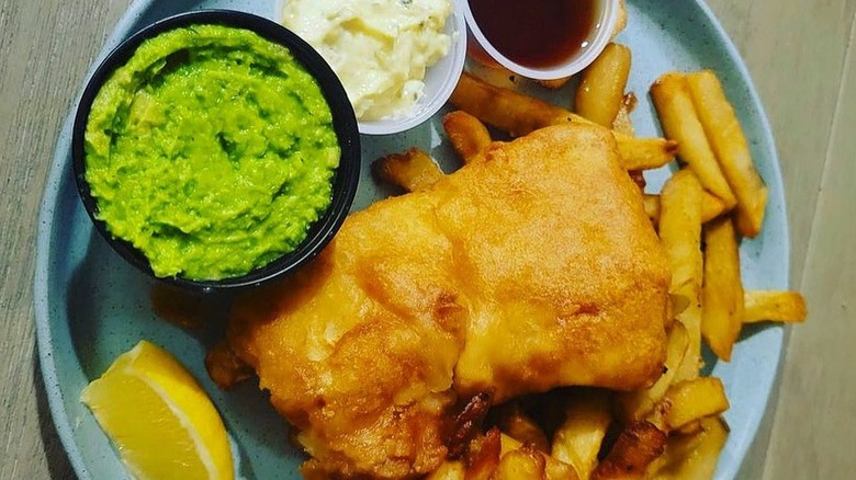 plate of fish, chips, and mushy peas