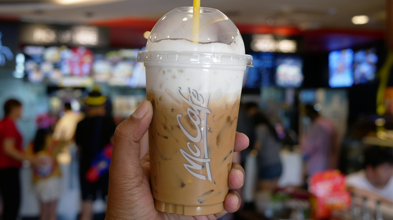 Hand holding McDonald's iced coffee