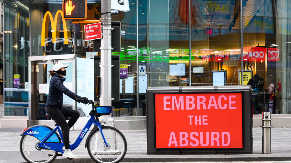 McDonald's in Times Square with "embrace the absurd" sign