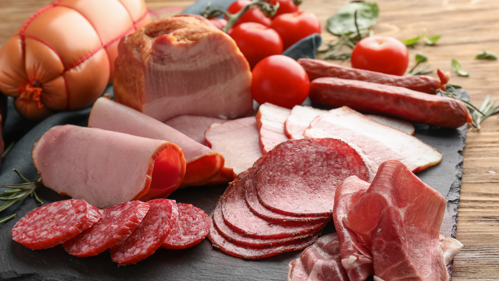 Deli meats on a wooden plate