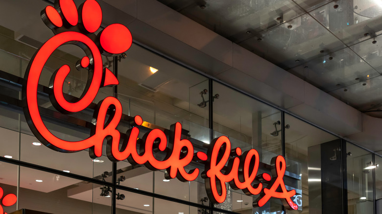 Chick-fil-A logo on a background of glass windows