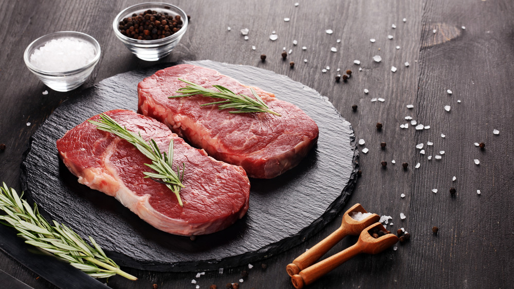 raw steak displayed with spices