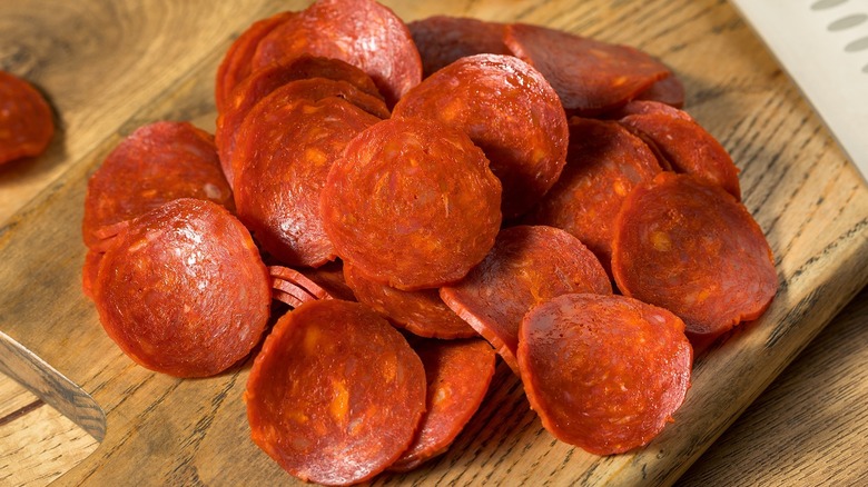 Sliced pepperoni on a cutting board