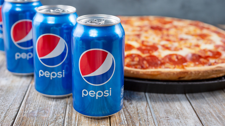 Cans of Pepsi with pizza