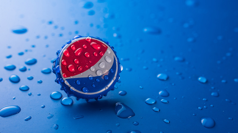 Pepsi bottle cap on blue background