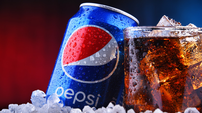 A can of Pepsi sitting next to a glass