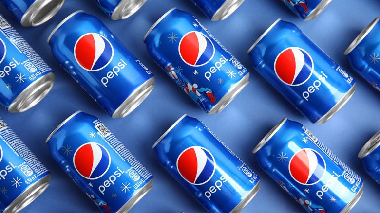 pepsi cans on blue background