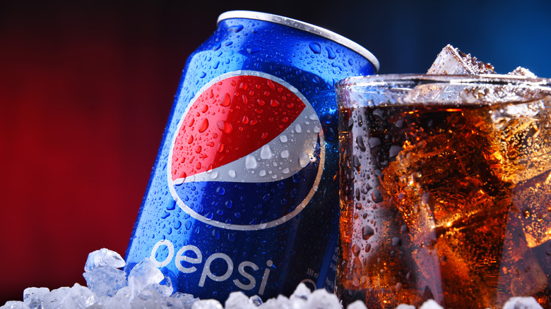 Pepsi can and ice-filled glass