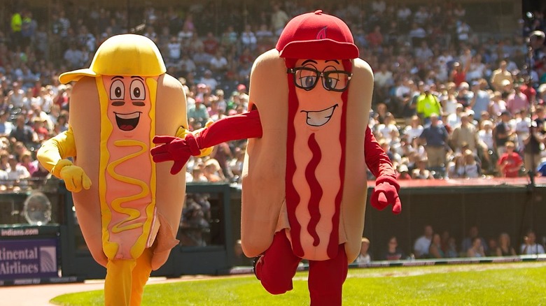 Hotdog costumed people at a baseball game