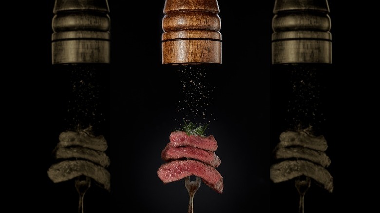 Steak being seasoned