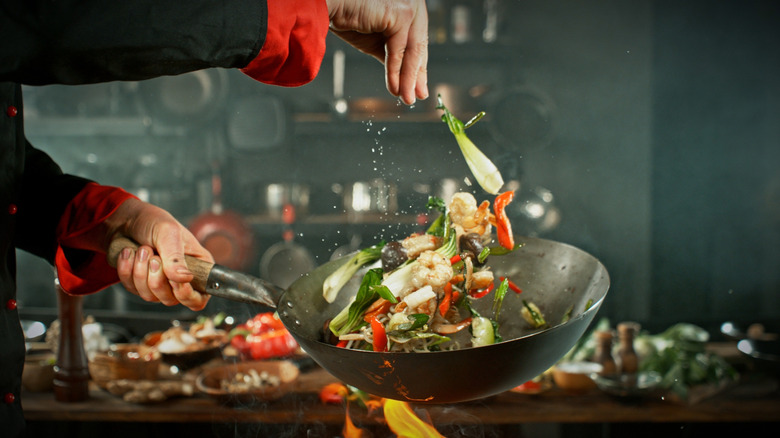 Cooking in a wok over fire