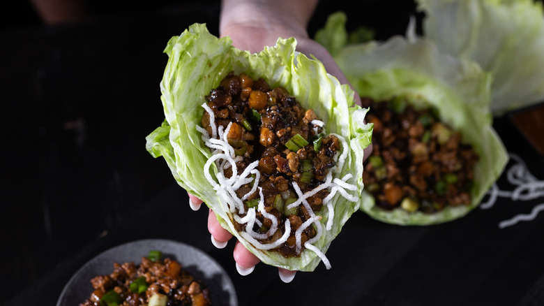 P.F. Chang's lettuce wrap in someone's hand
