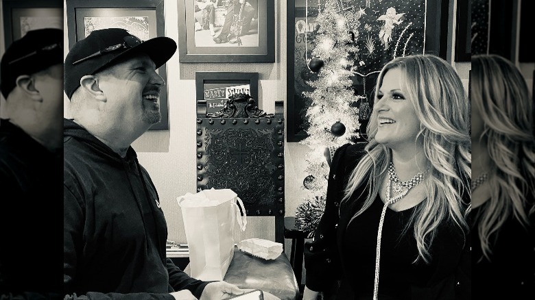 Garth Brooks and Trisha Yearwood smiling at each other