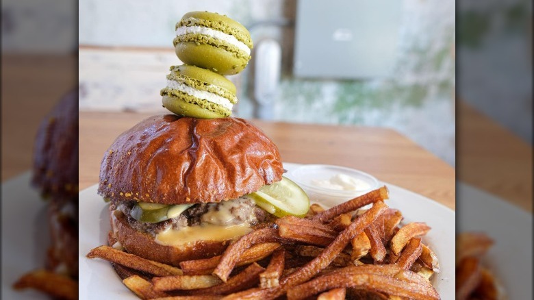 pickle flavored macarons atop a burger