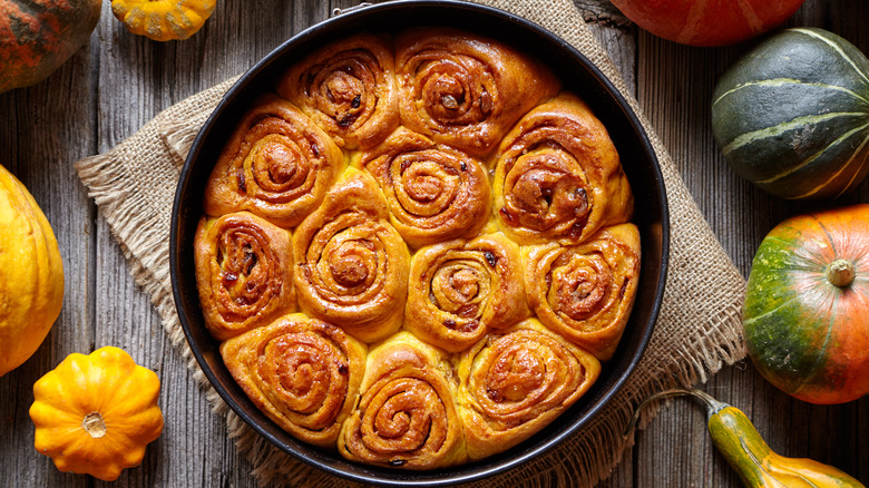 Cinnamon rolls in pan with autumnal accents