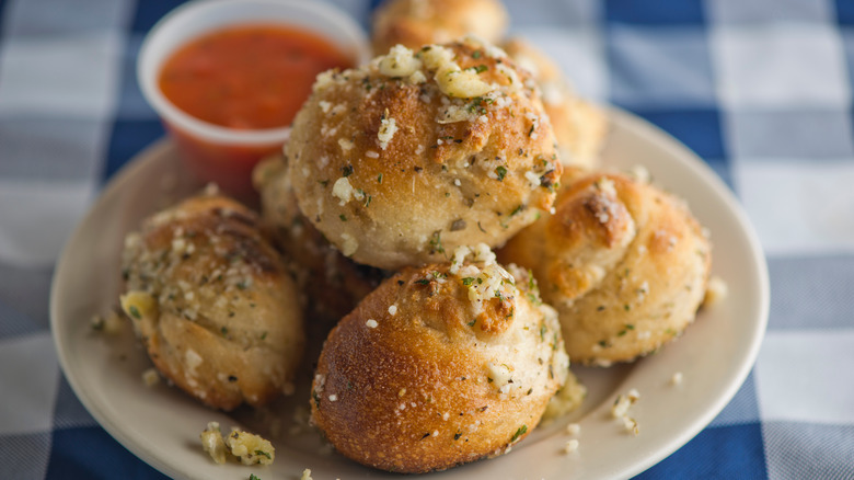 cheesy garlic knots with a side of dipping sauce