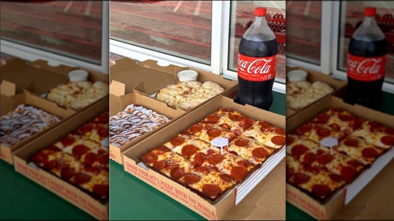 Jet's Pizza pepperoni pie in box with dessert, cheesy bread, and Coca-Cola bottle nearby
