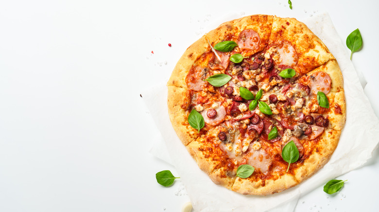 Top view of an Italian pizza on a white surface