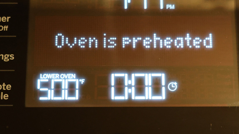 Oven with display reading oven is preheated to 500 degrees Fahrenheit