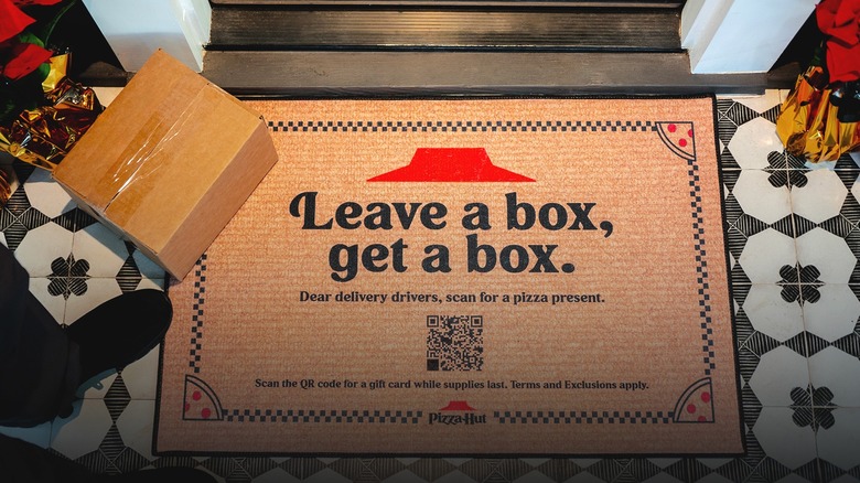delivery person leaving a box at a Pizza Hut doormat