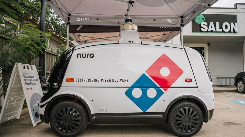 Domino's self-driving pizza truck parked in lot
