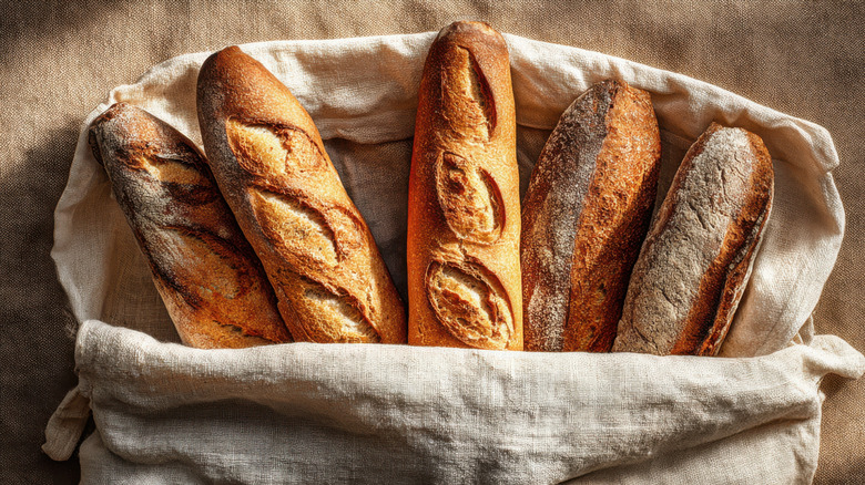 Baguette loaves in a brown linen bag