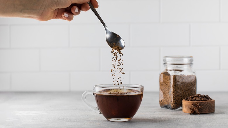 Person making instant coffee