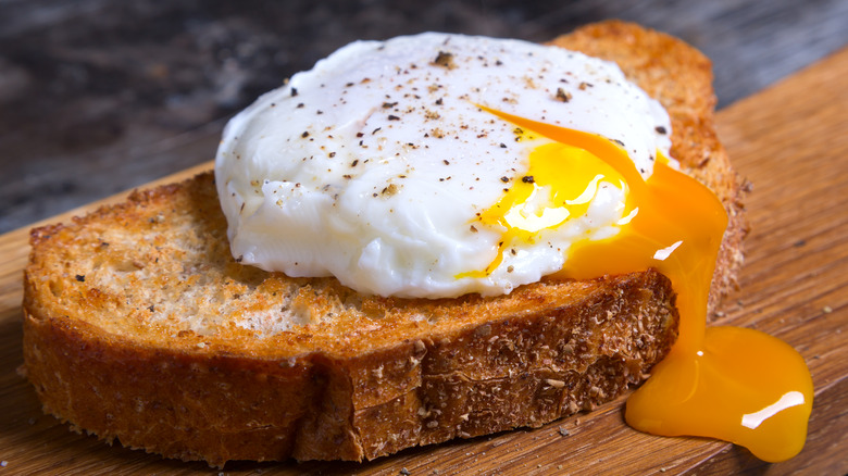 Runny poached egg on toast